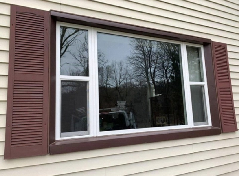 Window installation with red shutters